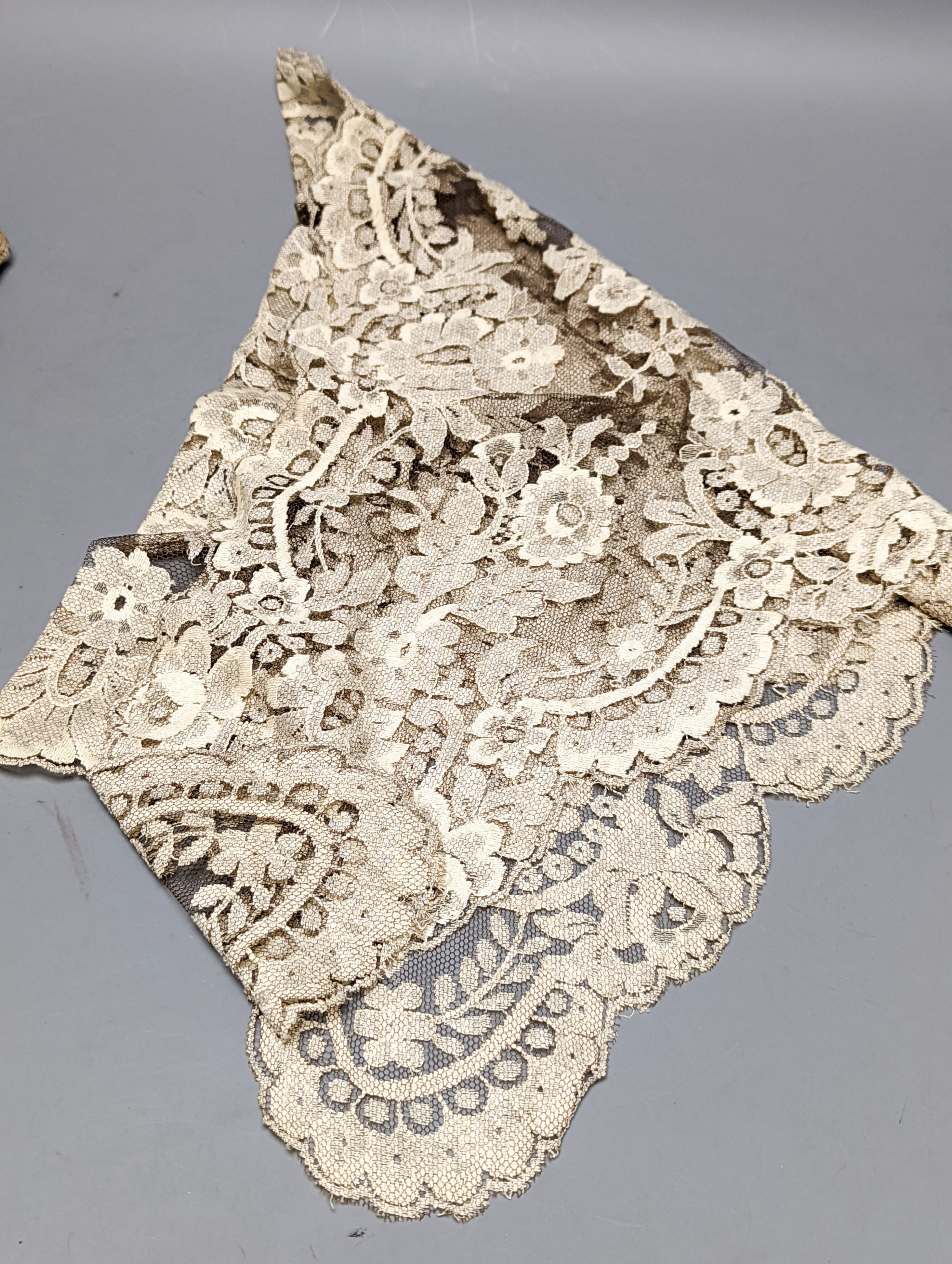 A filet lace box containing a silk Maltese hand bobbin lace veil and stole and an Irish crochet collar and machine net veil